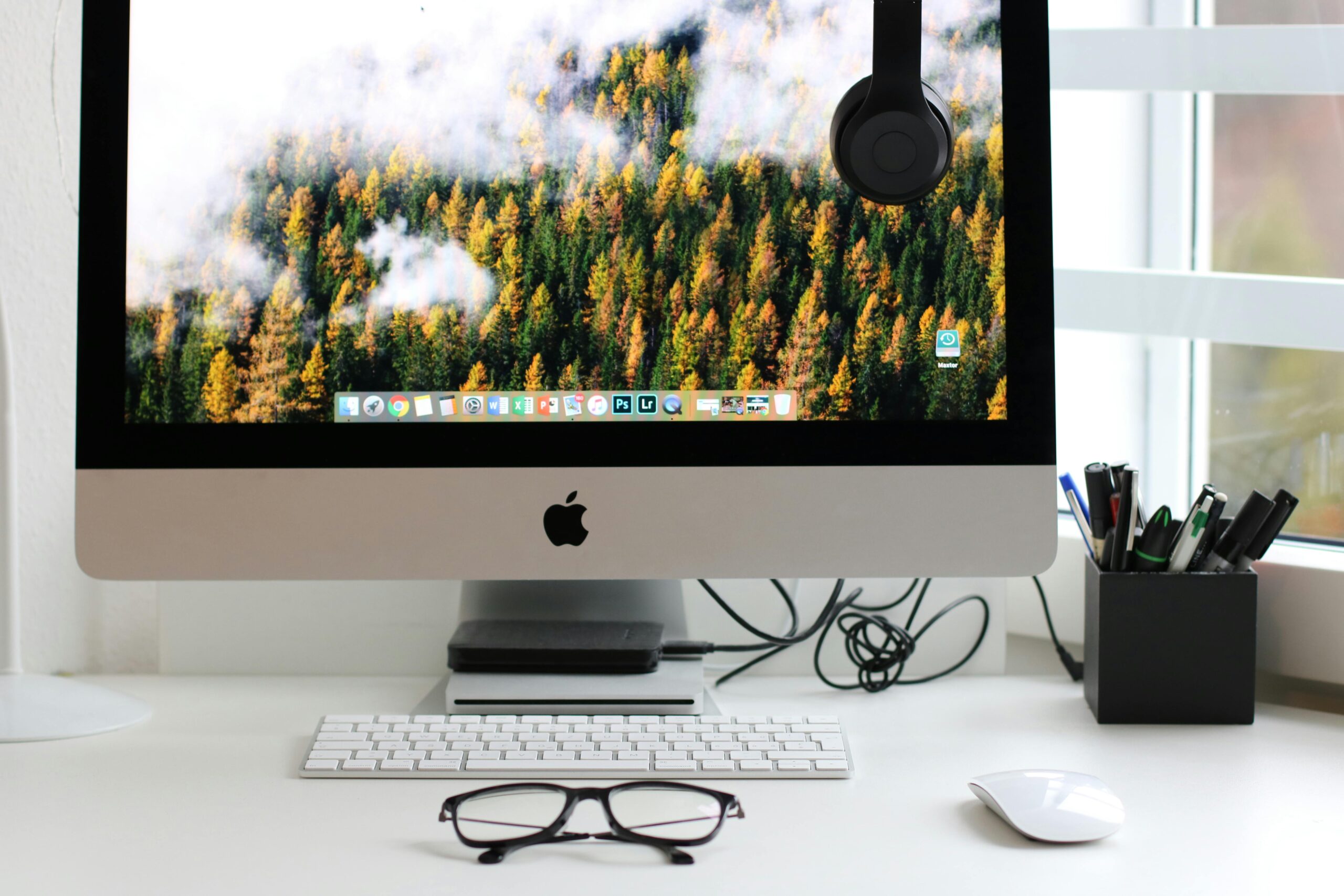 Home 25 Free Stylish Home Office Workspace Featuring A Computer Setup With Accessories. Stock Photo