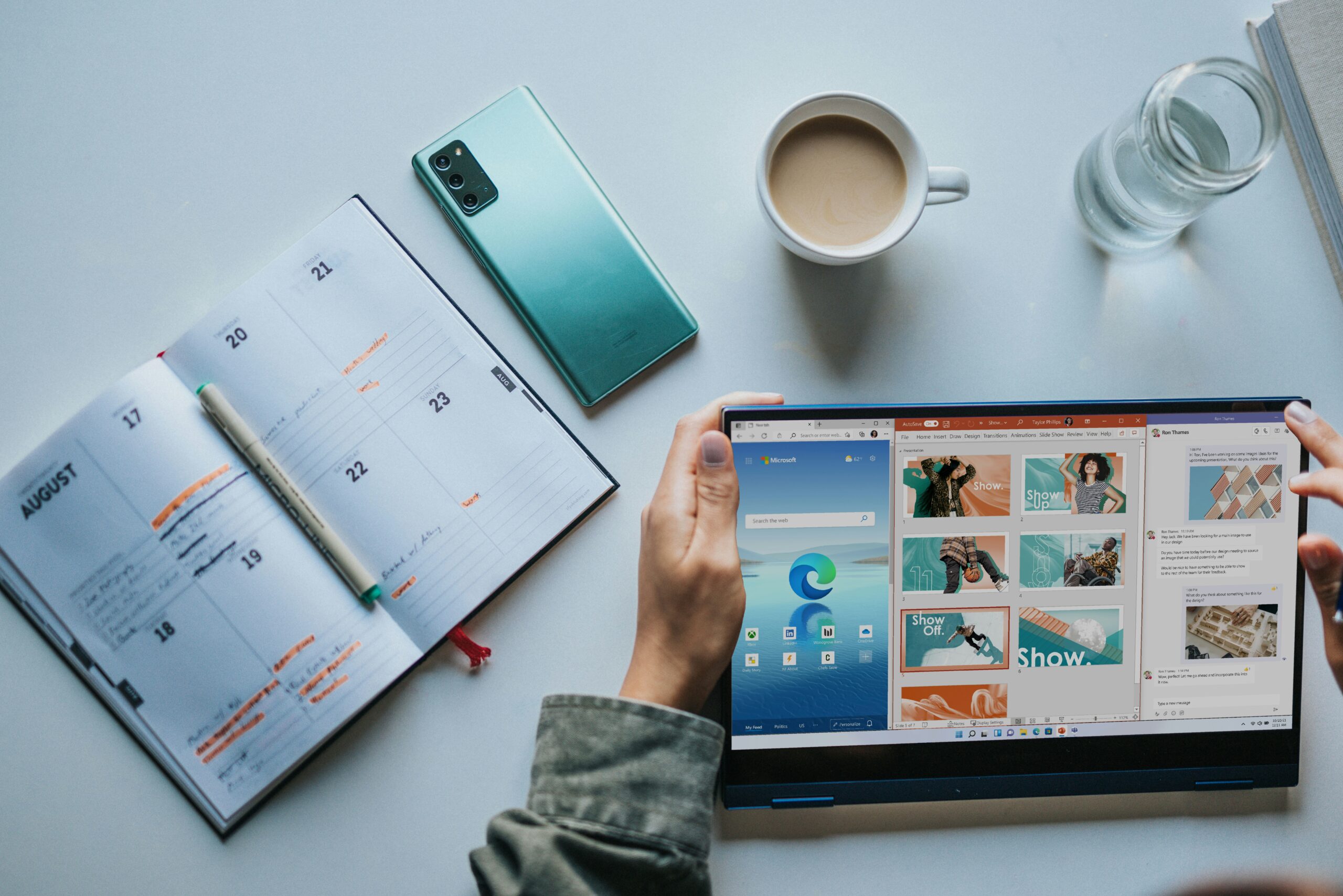 Person Using Windows 11 Computer Beside White Ceramic Mug On White Table