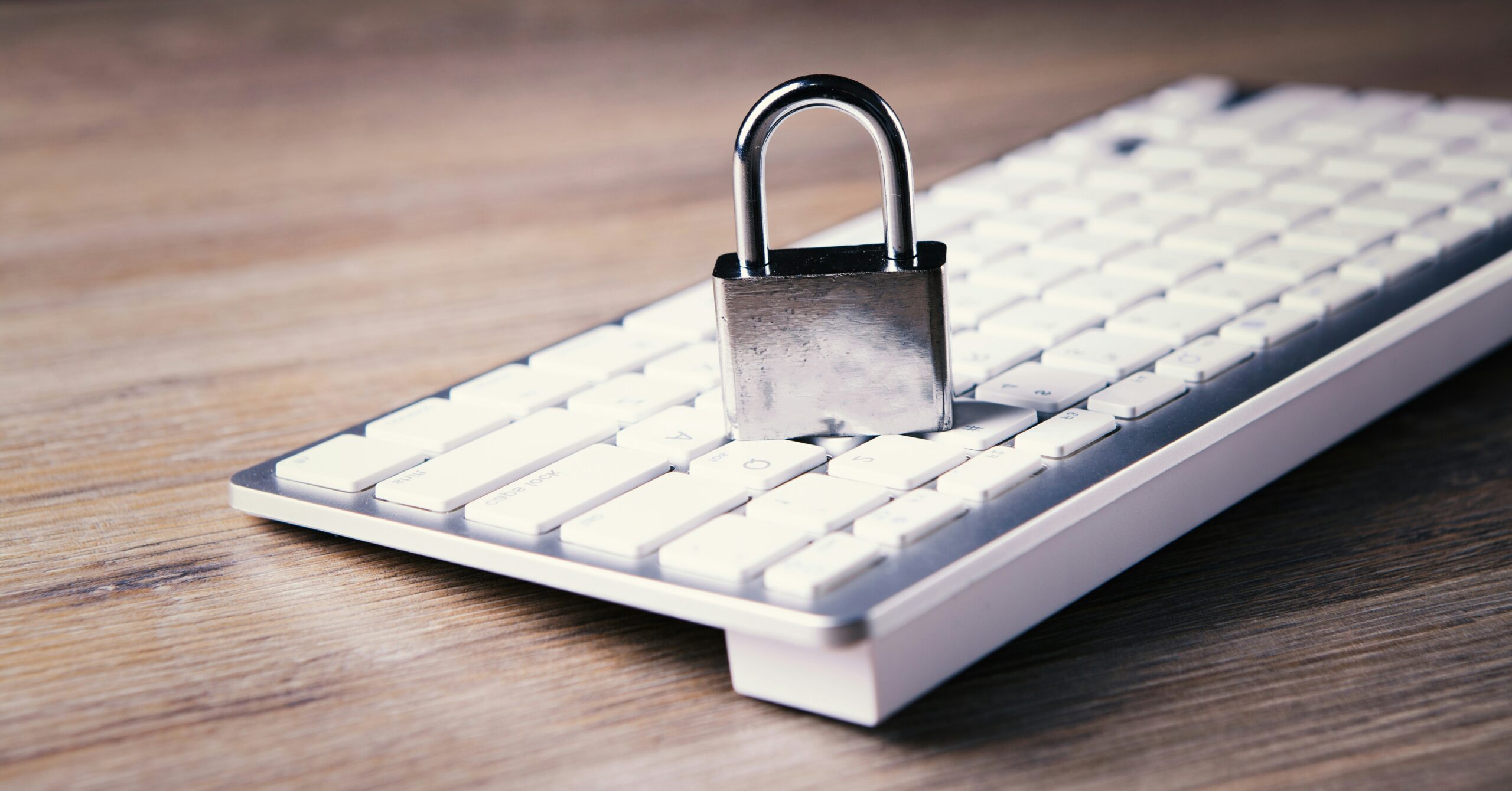 Home 25 A Computer Keyboard With A Padlock On Top Of It