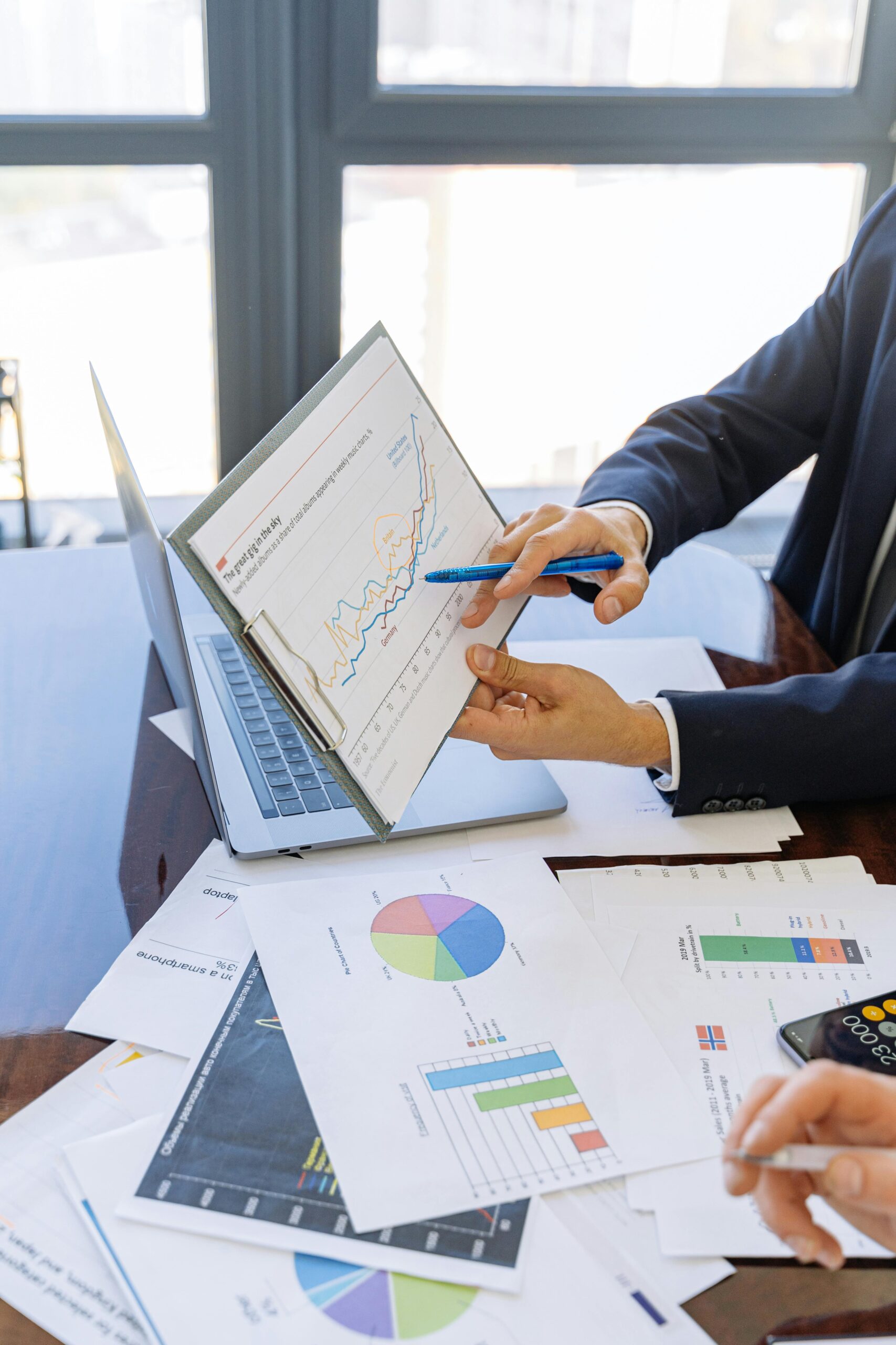 Home 25 Free Business Professionals Discussing Financial Graphs And Charts In An Office Setting. Stock Photo