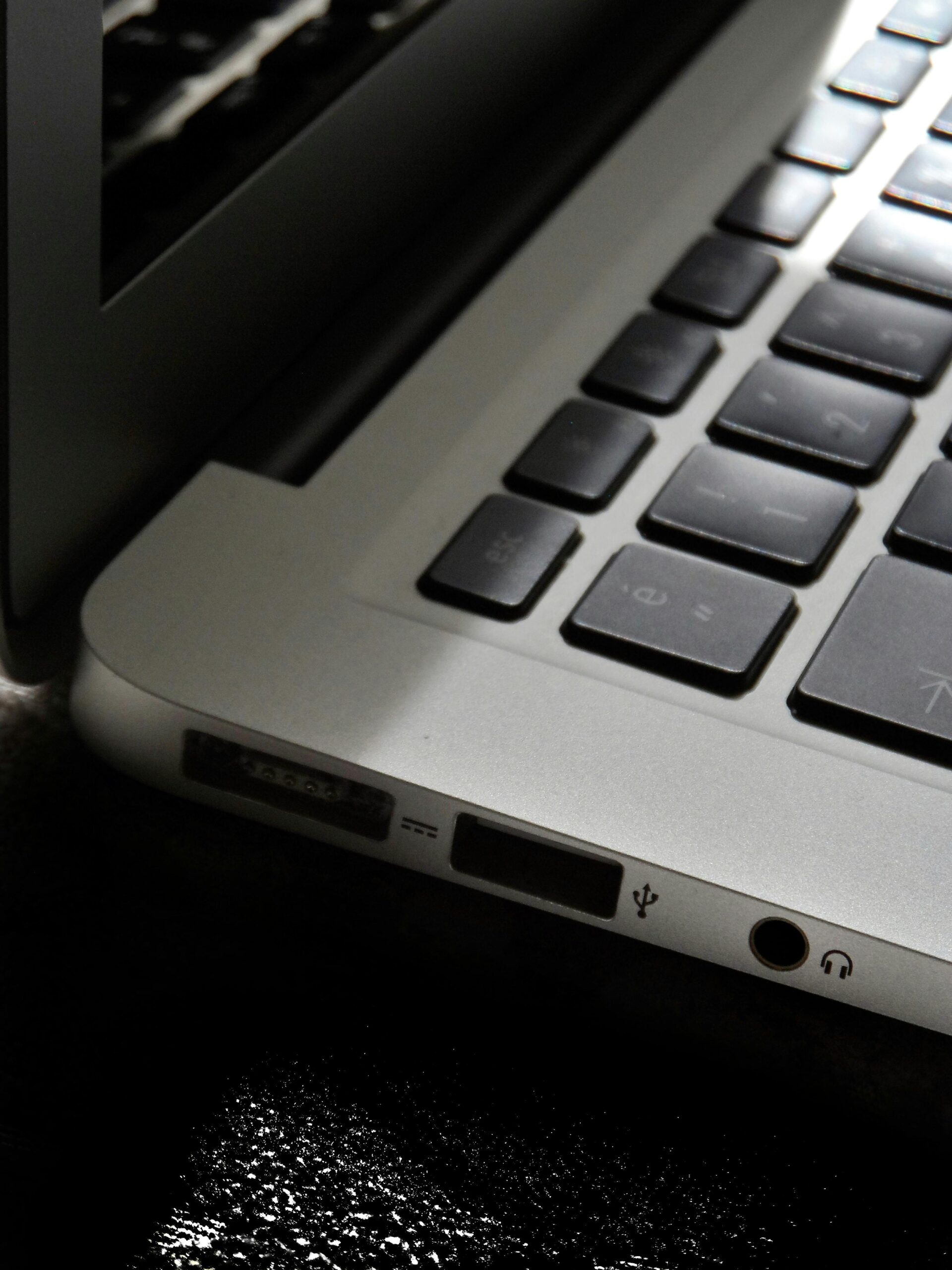 Home 25 Free Detailed View Of A Silver Laptop Showing Keyboard And Multiple Ports. Stock Photo