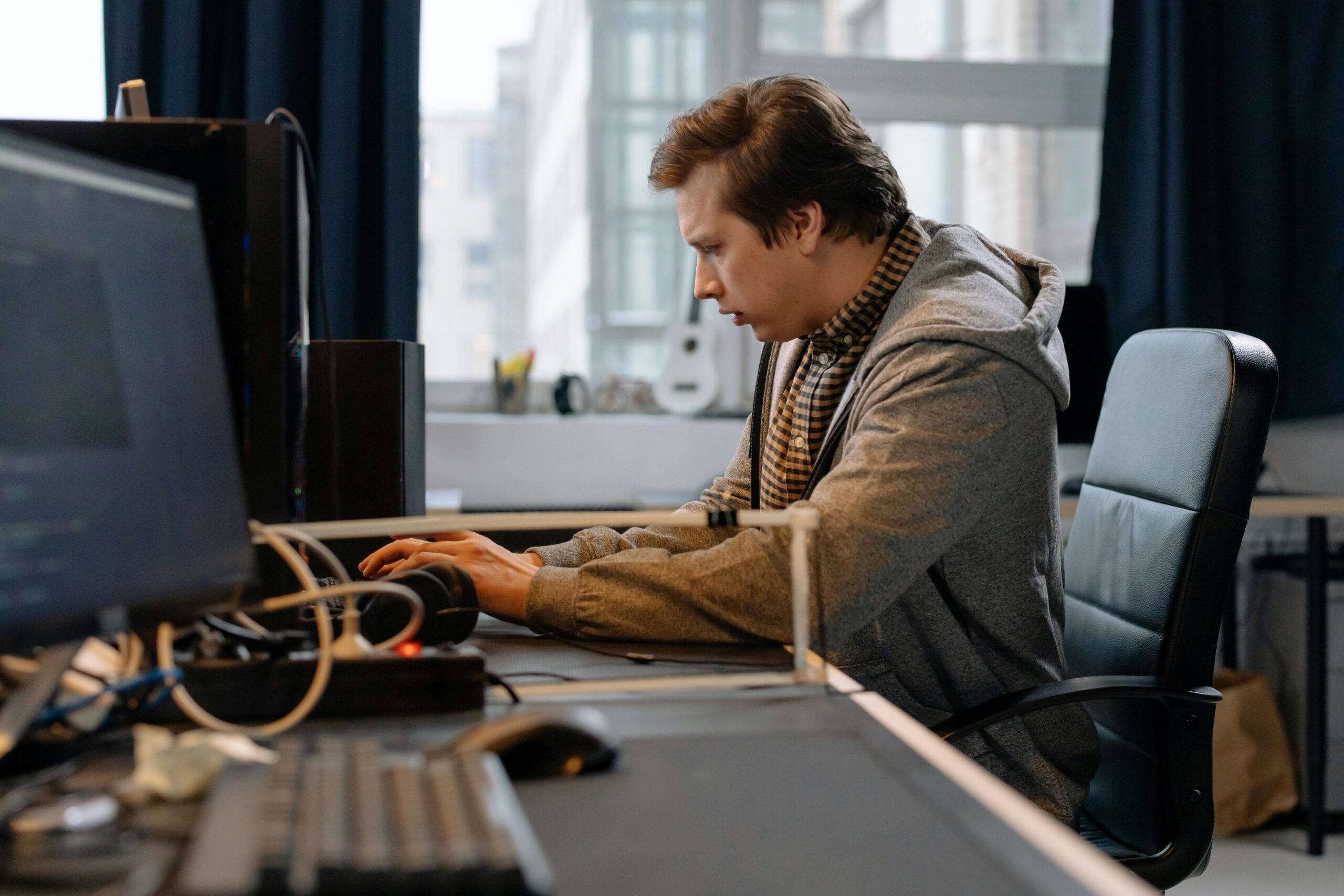 Home 25 Free A Concentrated Professional Working At A Computer In A Modern Office Setting. Stock Photo