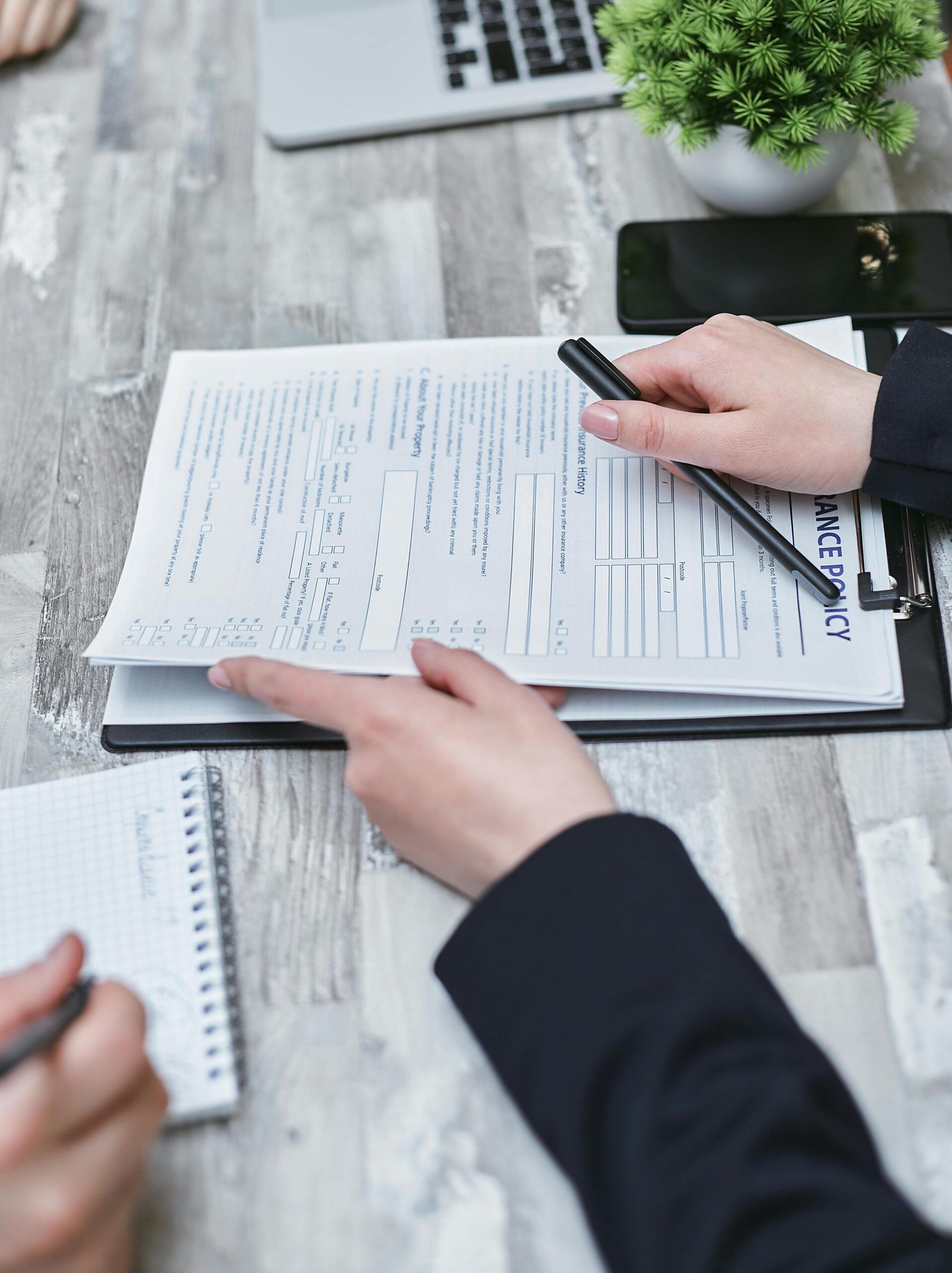 Home 25 Free Close-Up Of Hands Analyzing Insurance Policy Paperwork With Pen On Table. Stock Photo