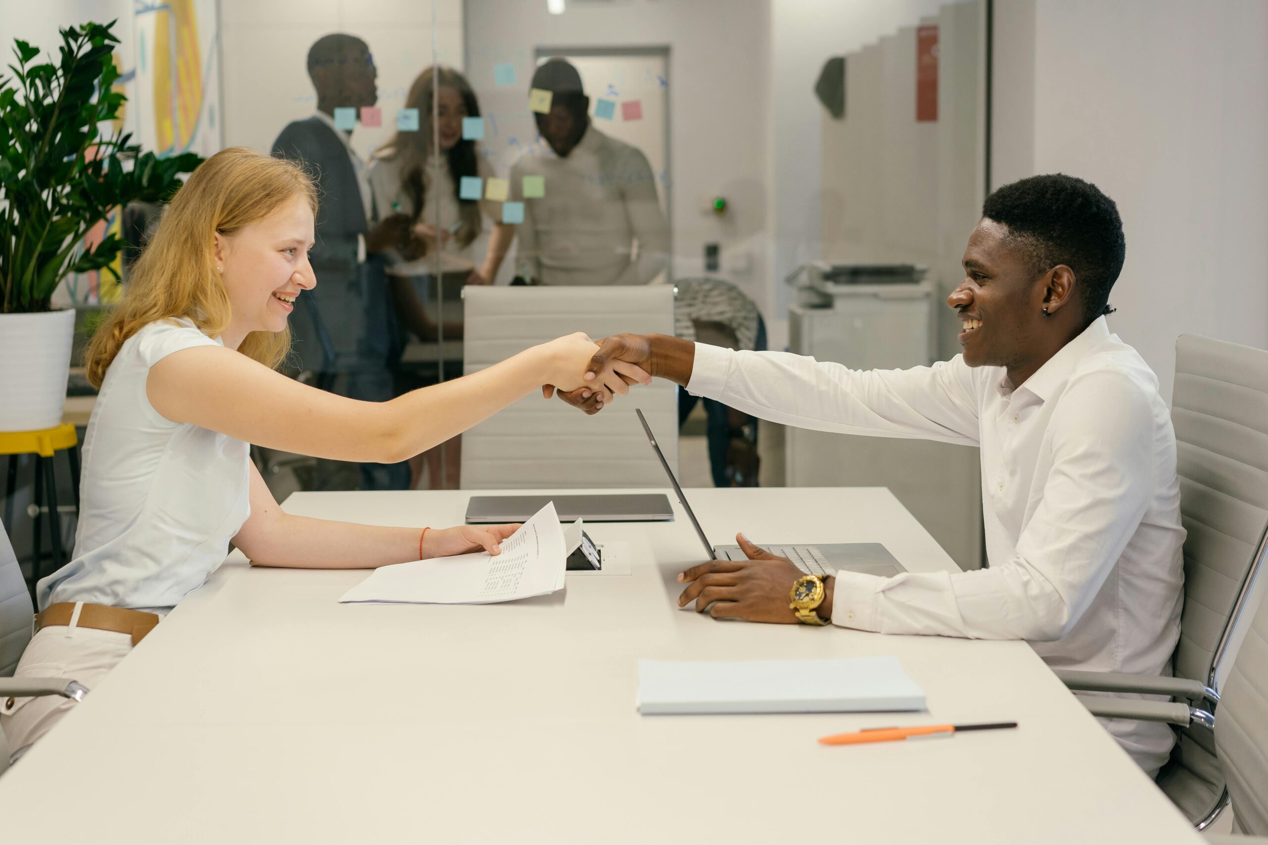 Home 25 Free Business Professionals Completing A Successful Deal With A Handshake In A Modern Office Setting. Stock Photo
