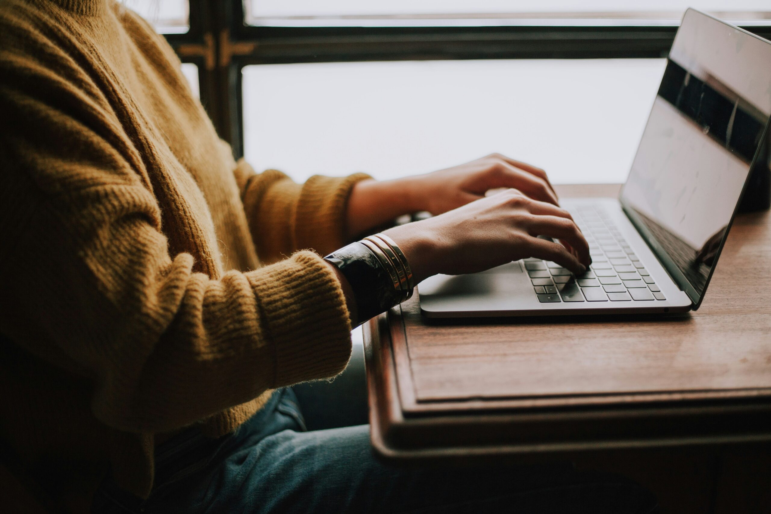Home 25 Person Sitting Front Of Laptop